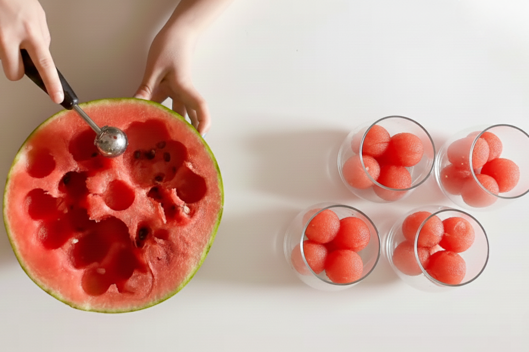 Making fruit balls using the Oxo melon baller for the watermelon fizz holiday mocktail recipe.