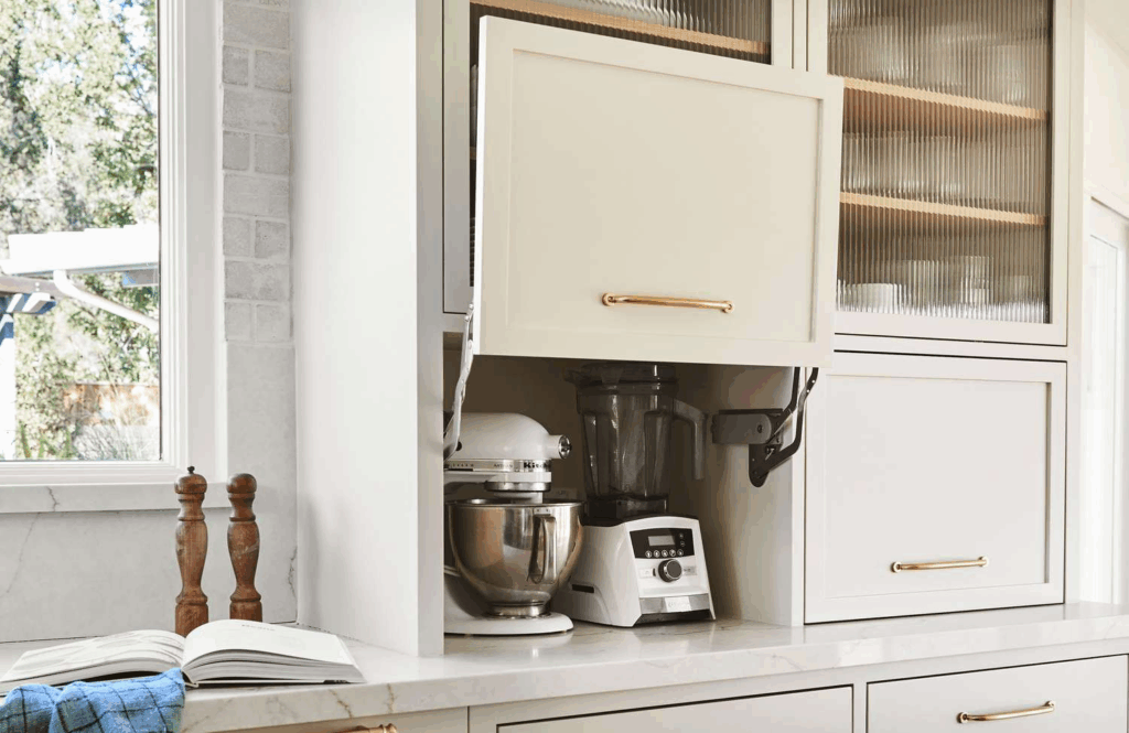 Modern kitchen lift-up appliance garage with hidden storage for kettles and small appliances, reflecting 2026 trends toward clutter-free, functional kitchen design.